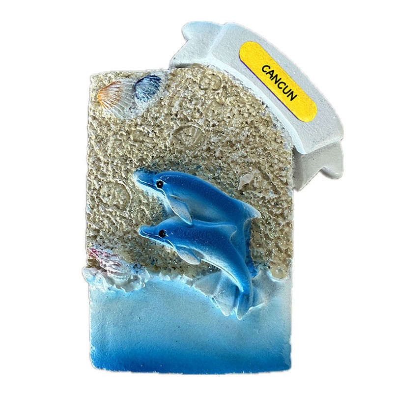 Magneto de resina con unos delfines. Souvenir de Cancún, México